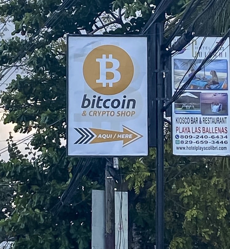 Picture of an orange sign for a bitcoin and crypto shop