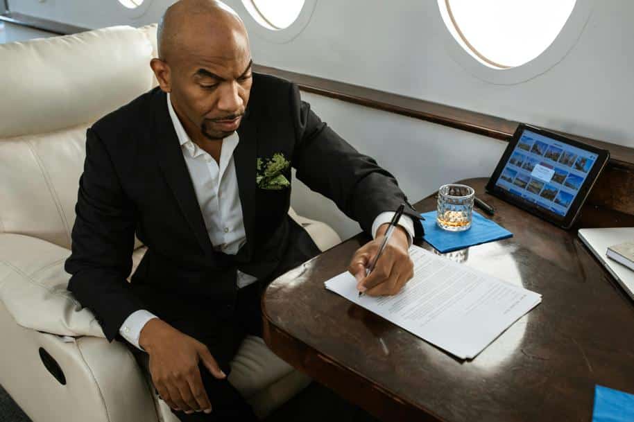 Businessman signing a Contract on a Private Jet