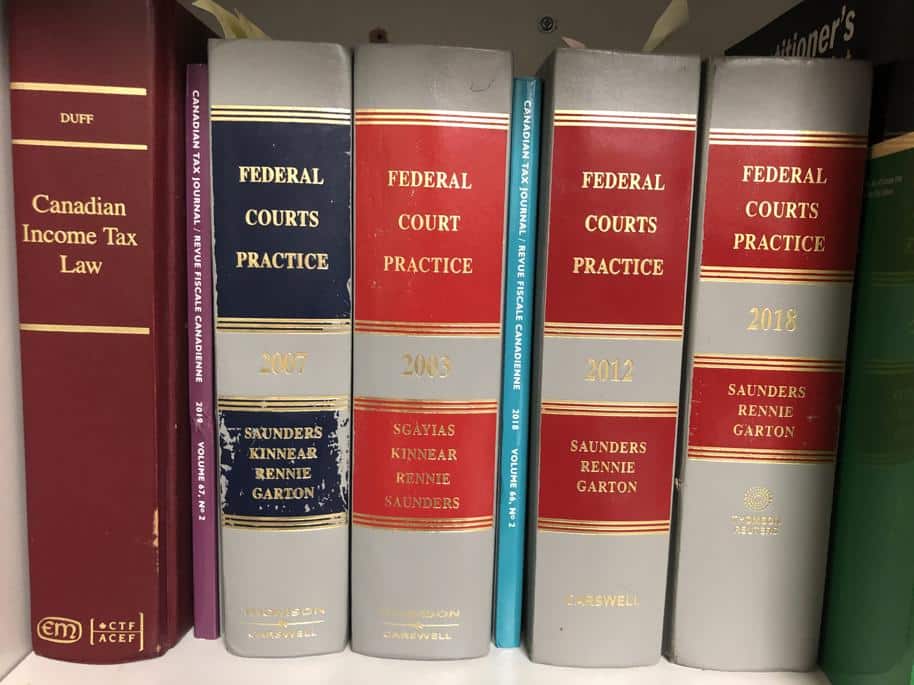 Federal Court Practice and Canadian Income Tax Law books on a shelf