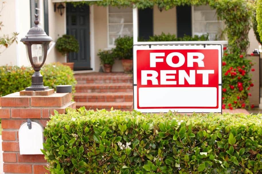 Home with a "For Rent" sign in front