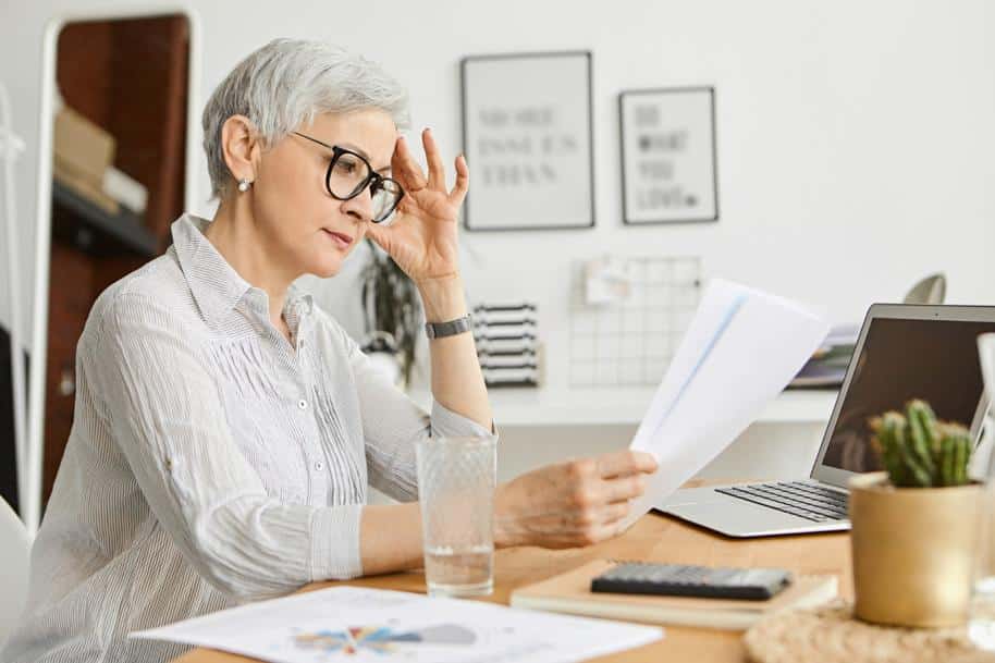 Woman looking concerned at a paper