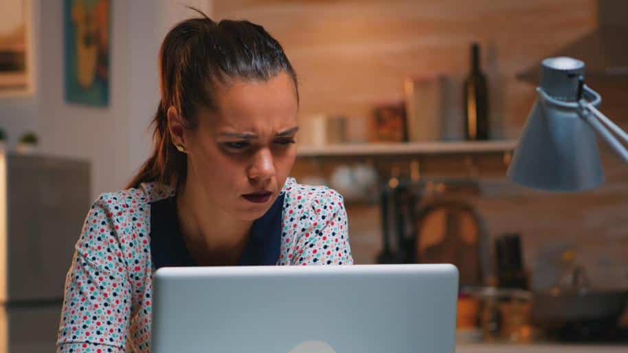 Woman looking confusedly at her laptop