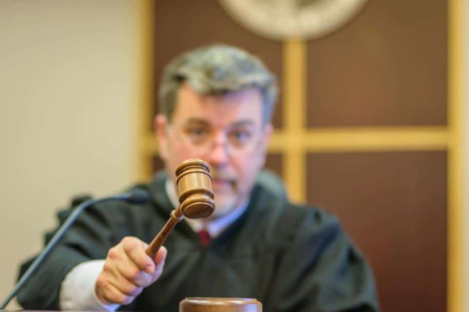 Close-up of a judge banging a gavel in a courtroom